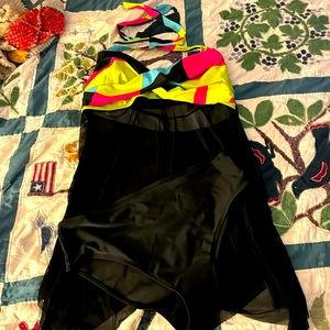 Two piece with black sheer top and black bottoms . Never worn